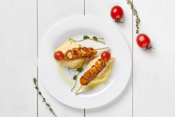 istock Chicken skewers with bacon and tomatoes with mashed potatoes 1323458222