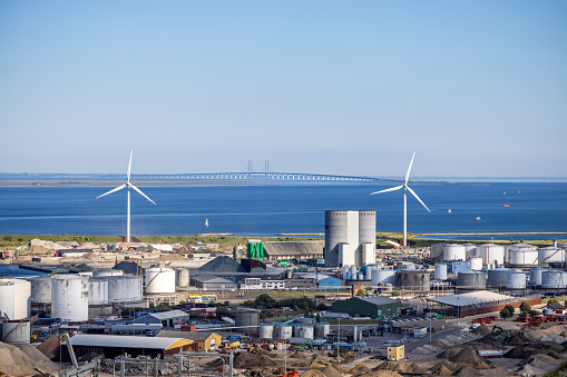 Industrial plant, wind turbines and the bridge between Denmark and Sweden seen from the coast north of Copenhagen
