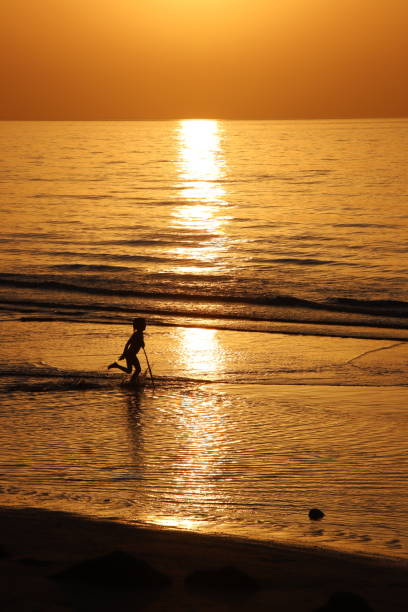 istock Girl playing at Beach in Oman 1323460073