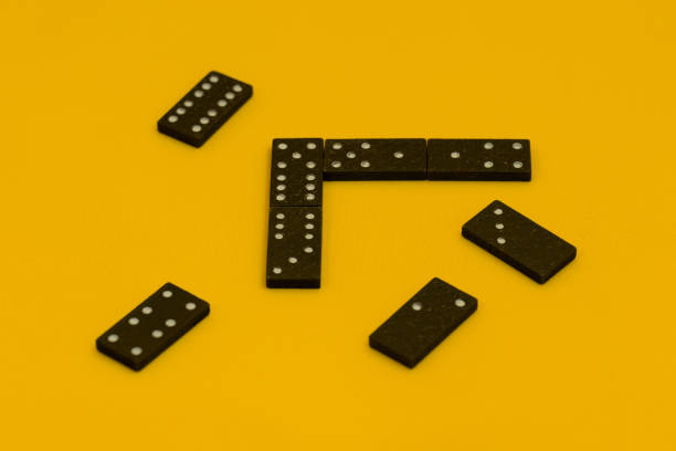 istock domino game on yellow background 1323460094