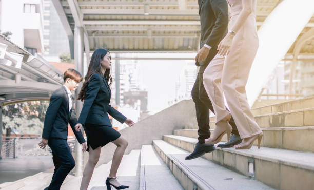 istock Business people walking on steps to work in the morning 1323461066