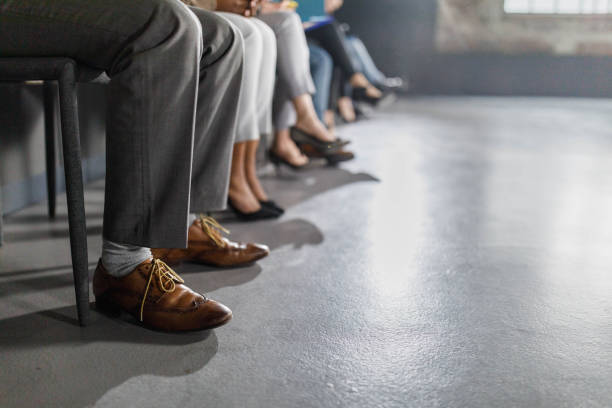 Large group of unrecognizable business people waiting for job interview in the office. Copy space.