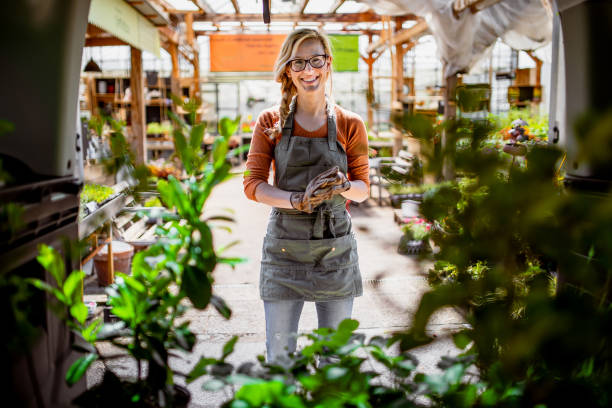 istock Garden Center Worker Transporting Plants 1323462342