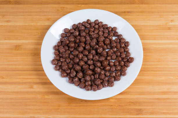 istock Breakfast cereal chocolate balls on dish on a wooden surface 1323462961