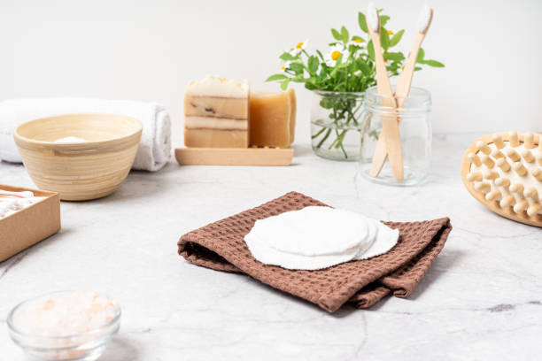 istock Natural bathroom and home spa tools. Zero waste sustainable lifestyle concept. Bamboo toothbrush, natural soap bar, cotton pads, homemade DIY beauty products in reusable bottles on white background 1323463460