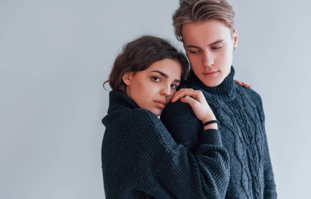 istock Cute young couple embracing each other indoors in the studio 1323464795