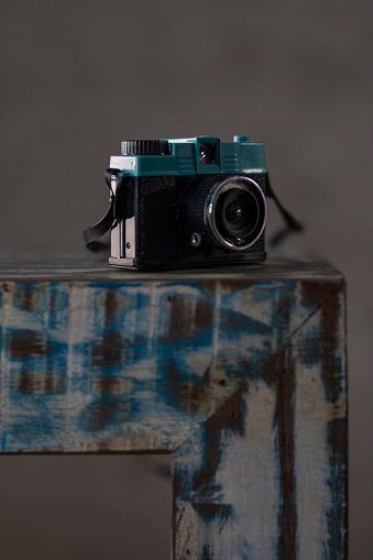 Old photographic camera with negative filme on the furniture