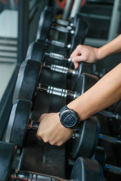 istock Strong well built bodybuilder lifting dumbbell weights getting ready for exercise in fitness 1323465328
