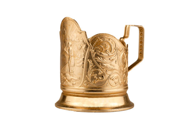 Cup holder isolated on a white background. Old gold-colored metal cup holder