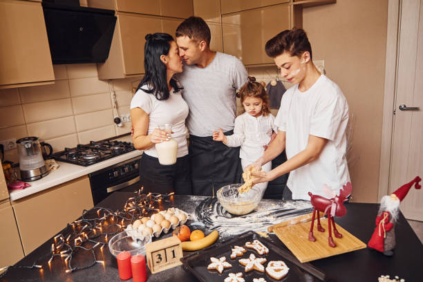 happy family have fun on the kitchen and preparing food - two parent family indoors home interior domestic kitchen imagens e fotografias de stock