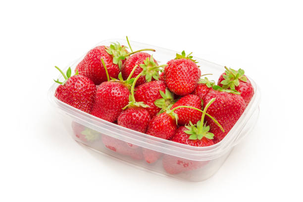 istock Freshly harvested strawberries in food container on a white background 1323470246