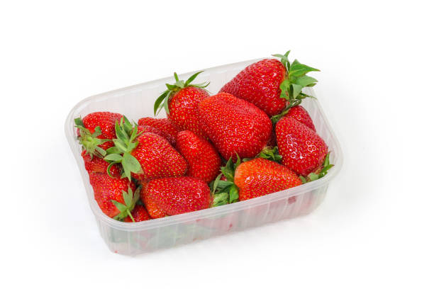 istock Fresh strawberries in translucent food container on a white background 1323470274