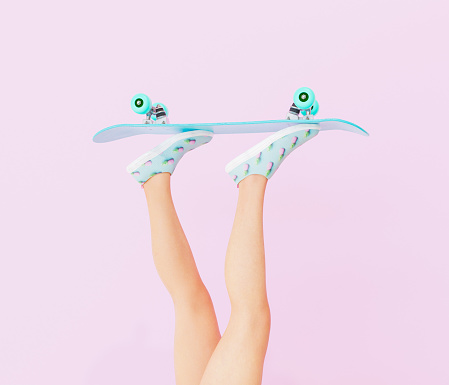 female legs with skateboard on pastel color background. vintage style. 3d render