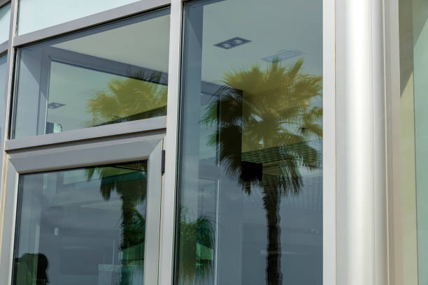 istock Reflection of palm trees in a glass door. 1323471433