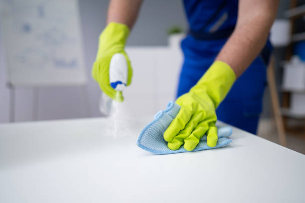 istock Man Cleaning The Glass Office Desk With Rag 1323471705