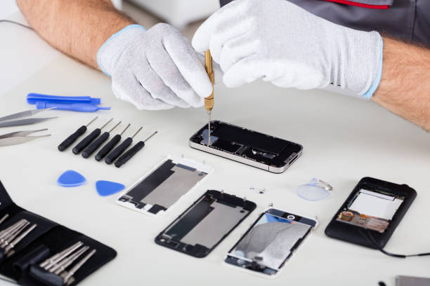 istock Person's Hand Repairing Cellphone 1323471862