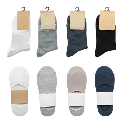 Pairs of cotton socks with blank labels on white background, collage