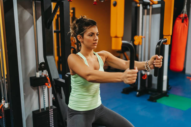 istock Attractive young woman exercising in gym 1323472912