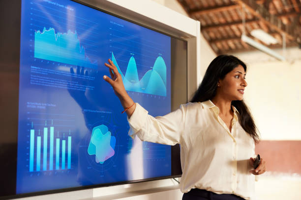 a businesswoman sharing charts in a presentation speech. - presentation imagens e fotografias de stock
