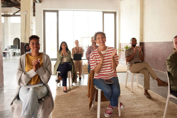 istock A woman in the audience clapping after a seminar. 1323473112