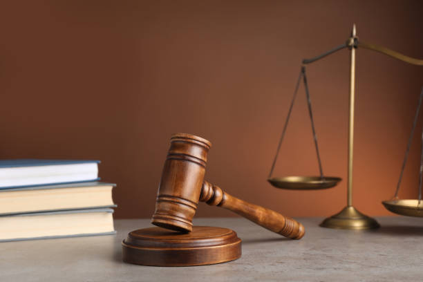 istock Wooden gavel on grey table. Law concept 1323473134