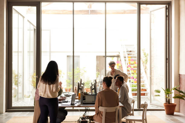 istock A group of people working in a creative office. 1323473398