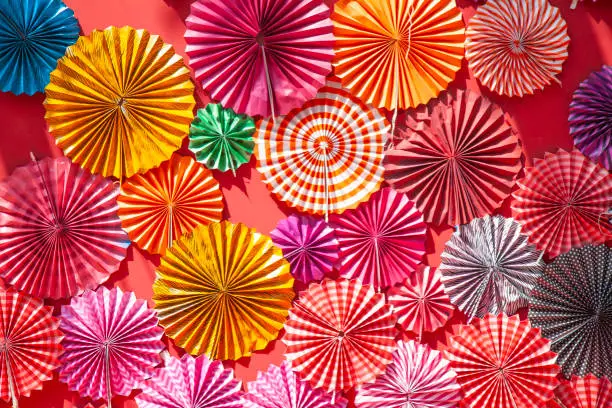 Photo of Colorful Circle shape folding paper fan in different sizes color and design background