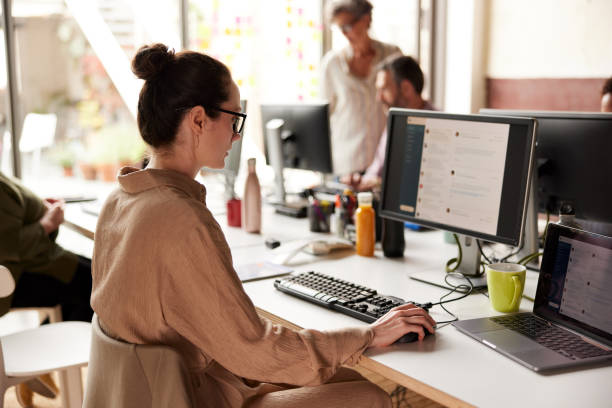 A businesswoman sending e-mails in an office.