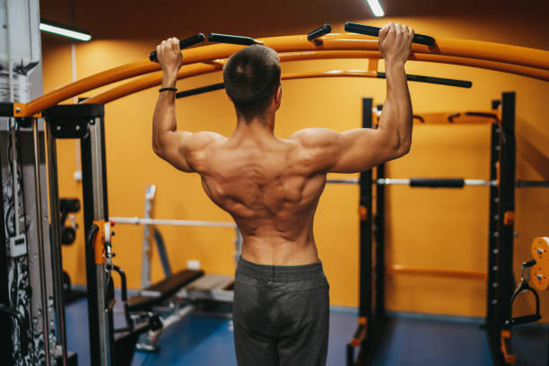 istock Handsome muscular man working out hard at gym 1323473762