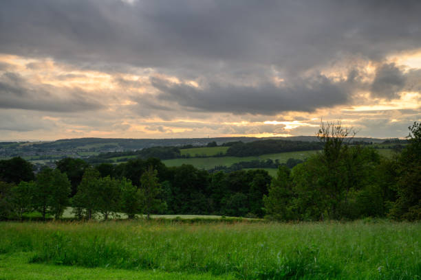 istock Cotswold Countryside with hills and trees 1323473843