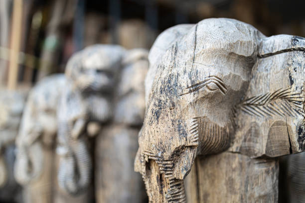 Closeup of elephant heads calved from old teak wood.
