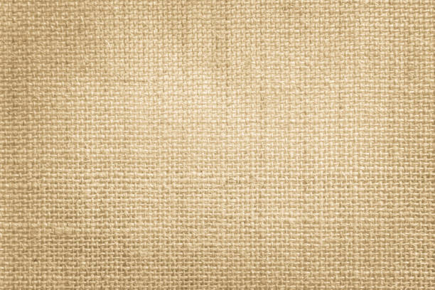 istock Jute hessian sackcloth canvas woven texture pattern background in light beige cream brown color blank empty 1323481010