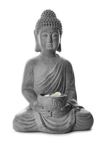 Beautiful stone Buddha sculpture with flower petals isolated on white