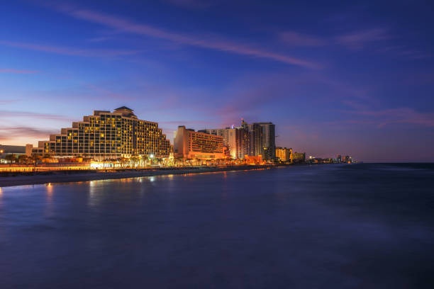 Night skyline of Daytona Beach in Florida, USA Night skyline of Daytona Beach, Florida, photographed from the fishing pier. Long exposure. daytona beach stock pictures, royalty-free photos & images