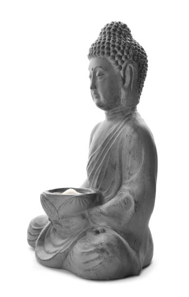 istock Beautiful stone Buddha sculpture with flower petals isolated on white 1323481454