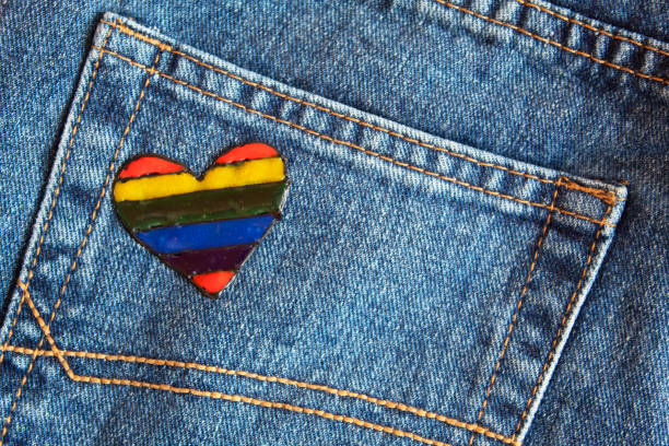 istock Rainbow heart on the background of blue jeans. 1323482171