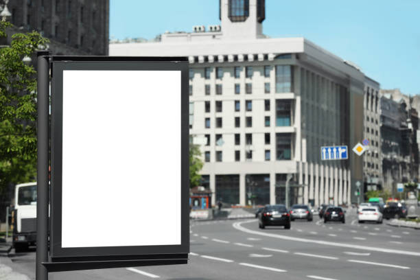 istock Blank advertising board on city street. Mockup for design 1323482321