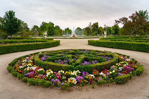 Aranjuez, Spain - June 5, 2021:\n Gardens with colorful flowers and shrub hedges in the royal palace of Aranjuez Spain.