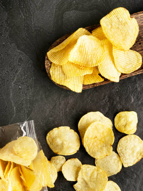 Chips spilling out of an open bag, Potato chips package, Potato chips, Chips on Black Background, Chips