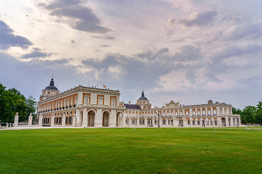 Aranjuez, Spain - June 5, 2021:\n Gardens and royal palace of Aranjuez in cloudy day at sunset. Madrid Spain.