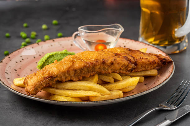 istock British Traditional Fish and chips with mashed peas, pea sauce and cold beer. 1323482809