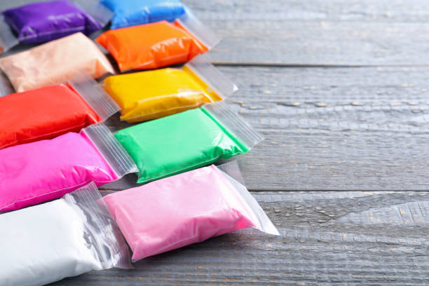istock Many packages of different colorful plasticine on grey wooden table, space for text 1323484129