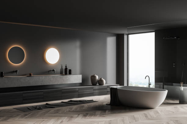 istock Bathroom interior with bathtub and shower, sinks with mirrors near window 1323484475