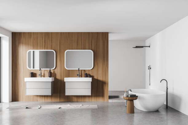 istock Bathtub and sinks with mirrors in light bathroom interior with shower 1323484521