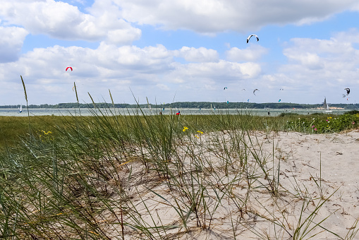 Lots of kite surfing activity at the Baltic Sea beach of Laboe in Germany on a sunny day.