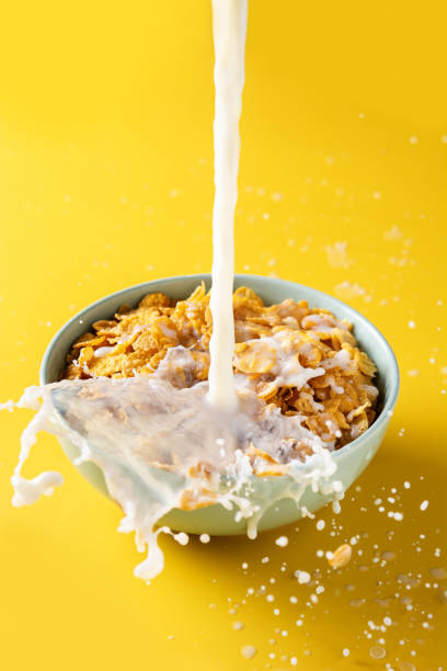 istock Pouring milk into bowl of corn flakes 1323485493