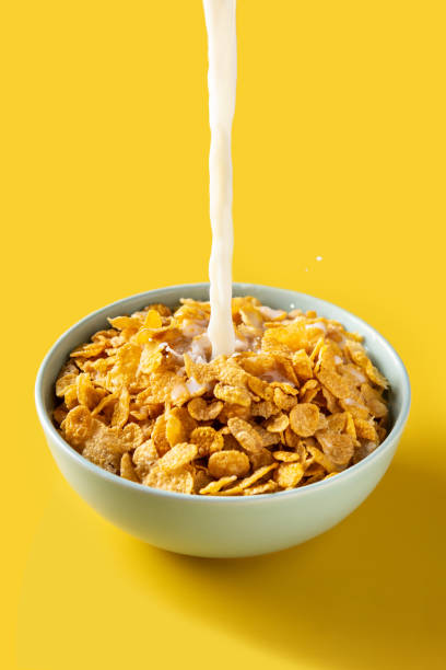 istock Pouring milk into bowl of corn flakes 1323485500