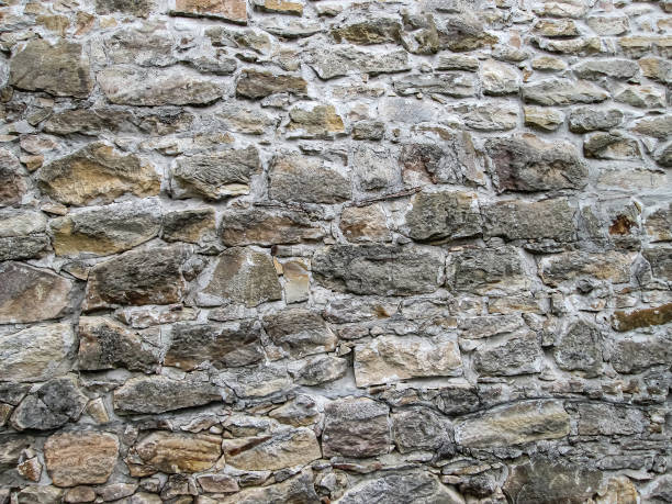 istock Large stone wall in light brown shades. 1323485782