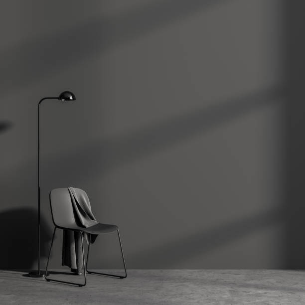 istock Empty room interior. Mock up grey wall with black chair and lamp. Concrte floor. Shadows from window. Copy space. 1323485834
