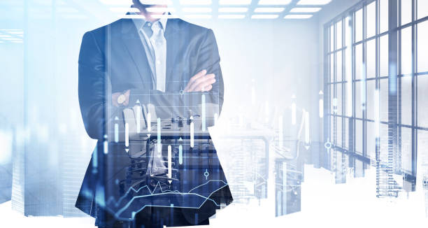 istock Businessman trader in crossed hands pose standing in modern panoramic international office. Pondering how to optimize trading strategy to boost income. Forex chart. Double exposure. New York 1323486842